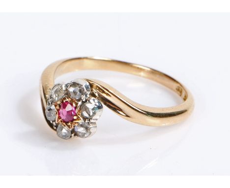 18 carat gold ruby and diamond set ring, with a central ruby and six diamond surround, ring size O