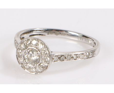 Platinum and diamond set ring, with a central diamond and diamond surround trailing down the shank, total diamond weight 0.67