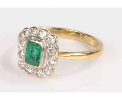 18 carat gold emerald and diamond set ring, the central emerald within the diamond set surround, 3.7 grams, ring size O