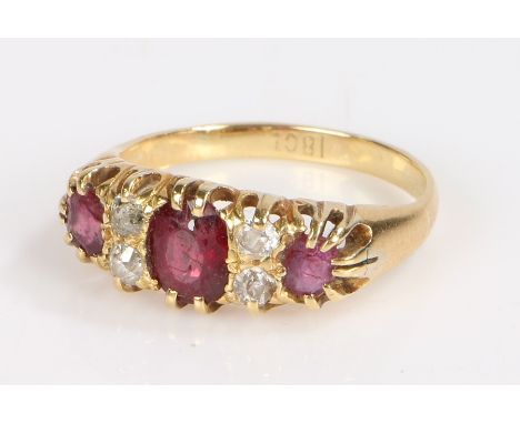 18 carat gold ruby and diamond ring, with three rubies and four diamonds to the head, 4.3 grams, ring size O