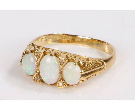 18 carat gold opal set ring, with three cabochon opals to the head, 5.9 grams, ring size Q