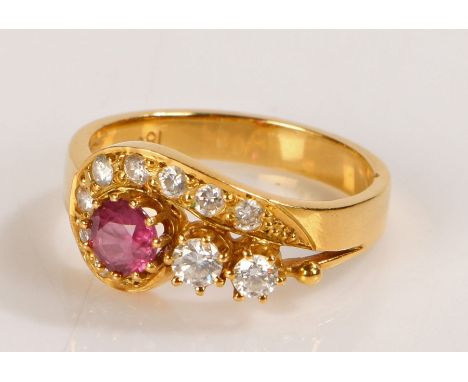 18 carat ruby and diamond set ring, with a central ruby and diamond swirl containing ten diamonds, ring size N