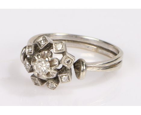 Diamond set ring, the white metal shank with a head set with nine diamonds, 4 grams, ring size O