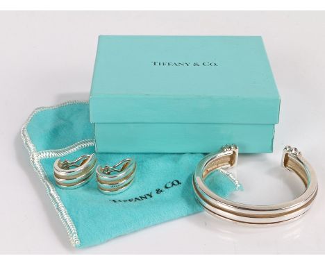 Silver Tiffany &amp; Co Bangle dated 1995 together with two silver earrings of the same year, gross weight 49.9g, housed in a