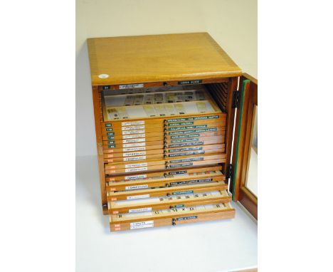 A Large Wooden Microscope Slide Cabinet, with various slides, lacking some draws and not all draws totally full