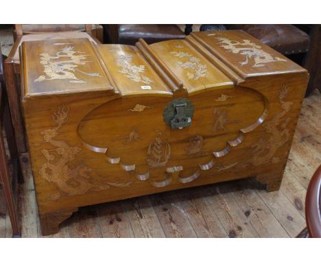 Oriental camphorwood trunk with dragon and floral decoration, 57cm high by 102cm wide by 51cm deep.