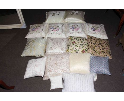 Fifteen scatter cushions including beaded and embroidered, and two canework light fittings.
