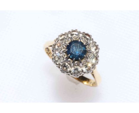 Sapphire and diamond cluster ring, the round sapphire bordered with ten brilliants set in 18 carat gold and platinum, 12mm di