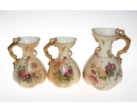 Three Royal Worcester blush ware coral handled jugs, all shape no. 1507, one 22cm, two 19cm, circa 1915/20.