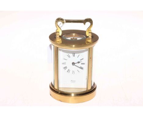 Gilt brass cased circular carriage clock, the face signed Huber, London, 15cm high.