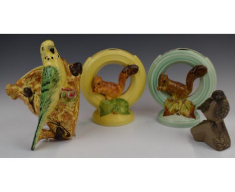 Two Burleigh Ware squirrel flower frogs, budgie wall pocket and a Poole pottery bird, tallest 20cm