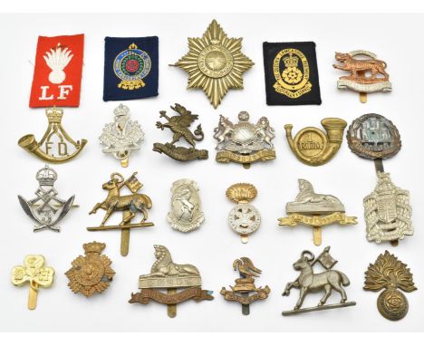 Approximately twenty British Army infantry badges including West Surrey Regiment, Manchester Regiment, Northamptonshire Regim