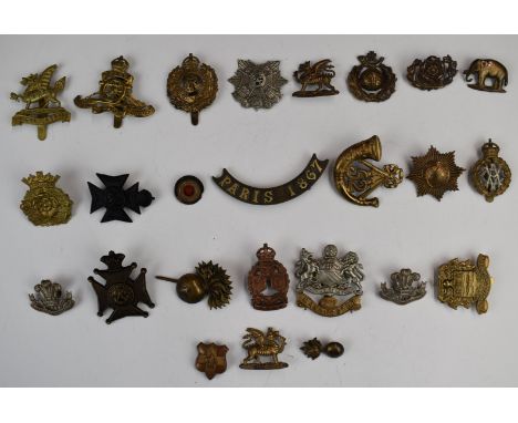 Approximately twenty British Army metal badges including Border Regiment, The King's Royal Rifle Corps, Brecknockshire Regime