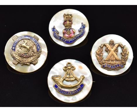 Four mother of pearl, metal and enamel sweetheart brooches including Liverpool Scottish Cameron's, Loyal North Lancashire, Ox
