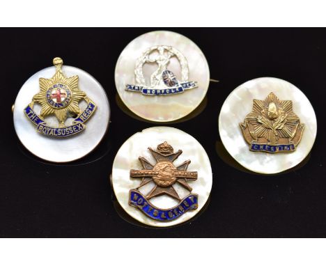 Four mother of pearl, metal and enamel sweetheart brooches for the Norfolk Regiment, Cheshire Regiment, Notts &amp; Derby Reg