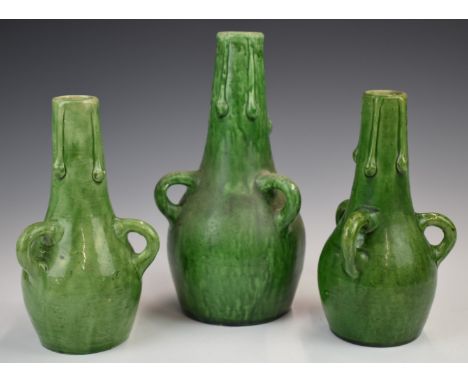 Farnham Art Pottery garniture of vases with loop handles and drip decoration, tallest 25cm