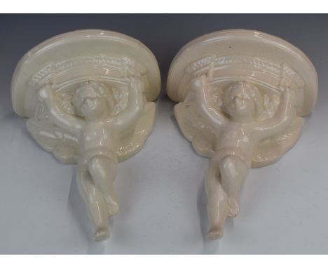 Pair of figural cherub pottery wall brackets with impressed marks verso 'FV B/Stone, Poole, England', height 30.5cm