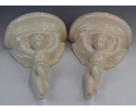 Pair of figural cherub pottery wall brackets with impressed marks verso 'FV B/Stone, Poole, England', height 30.5cm