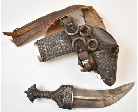 Middle Eastern Jambiya dagger with decorated hilt, 20cm curved blade, scabbard and belt.&nbsp;PLEASE NOTE ALL BLADED ITEMS AR