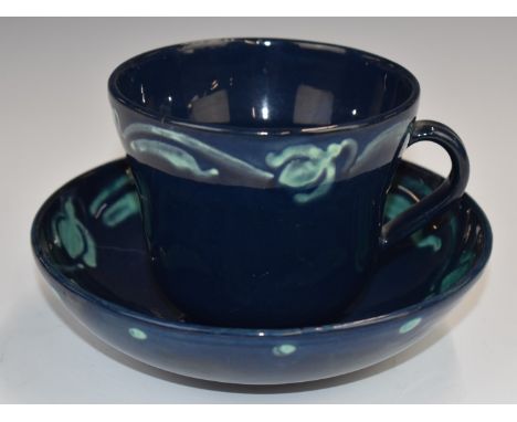 Della Robbia art / studio pottery rare cup and saucer with navy glaze and free flowing turquoise bird and whale / fish decora