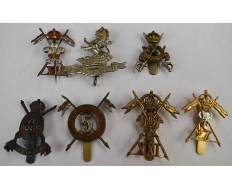 Seven British Army badges comprising 5th Lancers, 25th Dragoons, VI Dragoon Guards, 12th Lancers, 21st Lancers (Gaunt London 