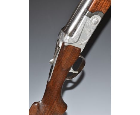 SKB 12 bore over and under ejector shotgun with engraved locks, underside, trigger guard, thumb lever and top plate, chequere