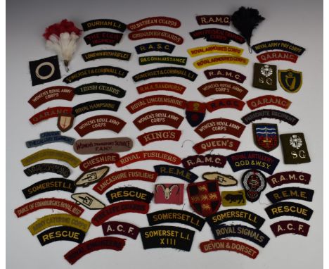 Approximately seventy Army cloth shoulder titles / badges, including RMA Sandhurst, Irish Guards, Parachute Regiment, Canada 