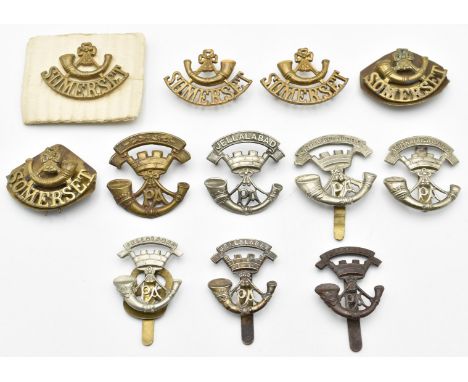 Twelve British Army Light Infantry badges for the Somerset Light Infantry, two with G R Gaunt London to reverse, some restrik