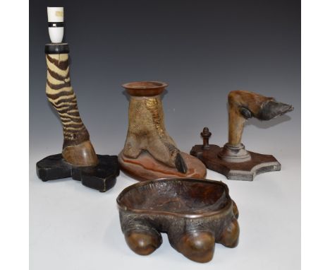 Four taxidermy interest items comprising a zebra hoof lamp, ostrich foot candle holder, an elephant foot dish and a deer slot