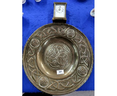 A Scottish brass celtic knotwork decorated charger together with a brass cased carriage clock Condition Report: Available upo