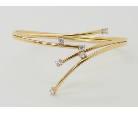 A 9ct gold cz set spray bangle, weight 6.4gms Condition Report: Available upon request