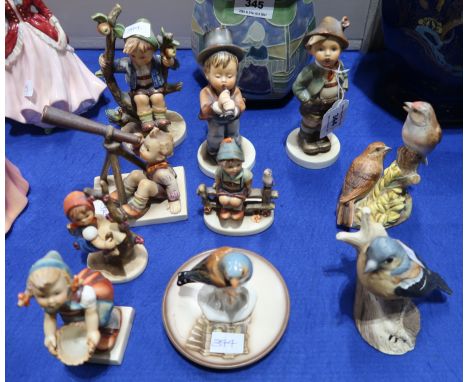 Seven Hummel figures, a plate and three ceramics bird groups Condition Report: Three of the Hummels are damaged and two of th