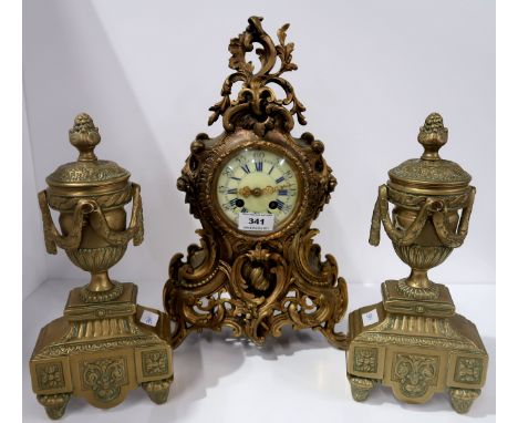 A French cast metal mantle clock, the dial with Roman numerals, together with a pair of brass urn garnitures Condition Report