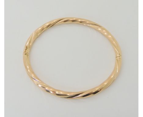 A 9ct gold twist pattern bangle, inner diameter 6.5cm, weight 8.6gms Condition Report: Available upon request