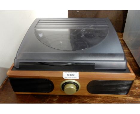 A small desk top vinyl record player with built in speakers Condition Report: Available upon request