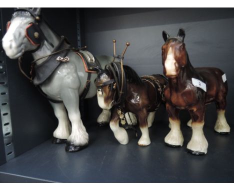 Three ceramic figurines working horses