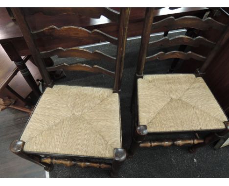 A pair of reproduction ladder back rush seated chairs
