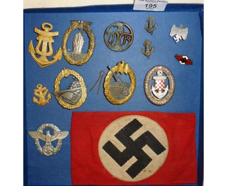 Collection of German WW2 cap badges and others, including a Swastika armband. Badges include Naval Coastal Artillery, Mineswe