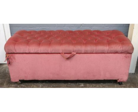 An ottoman, upholstered in pink velour, with button down hinged top, 122cm wide x 55cm deep x 49cm high.