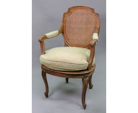 A pair of Louis XVI style beech fauteuil, early 20th century, with beaded and moulded frames, cartouche shape cane panel back