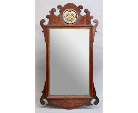 A 'Chippendale' style upright bevel edge wall mirror, in mahogany fret carved frame with pierced gilt roundel, 82.5cm high x 