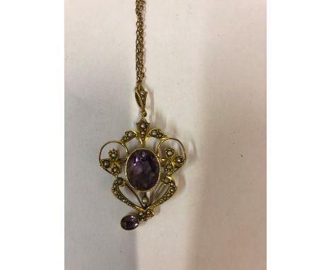 A 9ct Gold Amethyst and Seed Pearl Pendant, circa early 20th century, Set with a large amethyst to the centre, approximately 