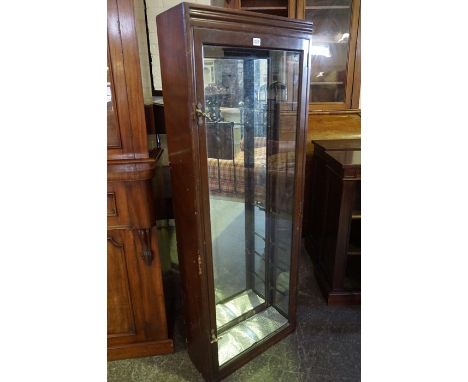 A Mahogany Shop Display Cabinet, circa early 20th century, Having a glazed door, lacking shelves, 153cm high, 57cm wide, 22cm