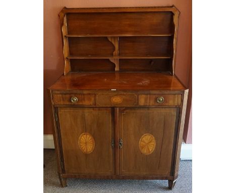 A George III Mahogany Inlaid Commode Chest, Having a hinged top enclosing a folding superstructure shelve, above two drawers 