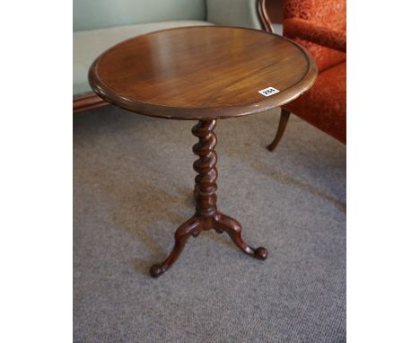A Victorian Mahogany Tea Table, Having a circular top, raised on a barley twist column and tripod scroll legs, 71cm high, 49c