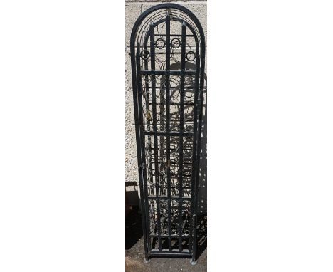 A Wrought Iron Wine Rack, Having a door enclosing 36 bottle inserts, 130cm high, 29cm wide, 35cm deep