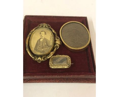 A Victorian Portrait Mourning Brooch, Having a revolving central portrait locket, with platted hair sample to the reverse, mo