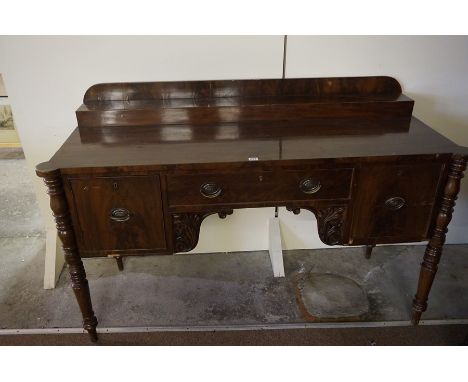 A Regency Design Mahogany Sideboard, circa 19th century, Having a central drawer, flanked with a cellarette drawer and a pane