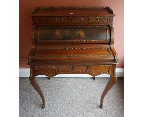A French Walnut Bonheur De Jour, circa late 19th / early 20th century, Having a gilt metal gallery, above a piano style rolle
