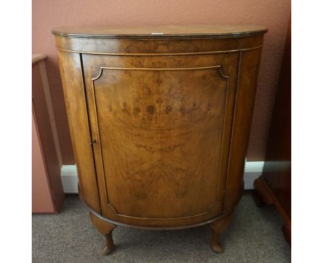 A Walnut Demi Lune Cupboard, Having a cupboard door enclosing two small drawers, raised on cabriole feet, 92cm high, 72cm wid